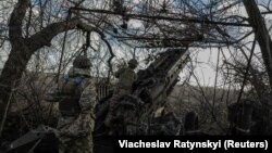 Військові 55-ї окремої артилерійської бригади готують гаубицю М777 для вогню по російських позиціях поблизу Мар’їнки, 26 грудня 2023 року