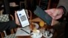 France - A woman shows a COVID-19 health pass in a cafe in Paris, August 9, 2021.