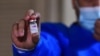 A nurse holds a vial of the AstraZeneca COVID-19 vial