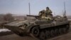 Ukrainian service members ride a BMP-1 infantry fighting vehicle near the frontline town of Bakhmut