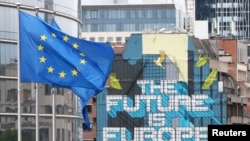European Union flags flutter outside the European Commission headquarters