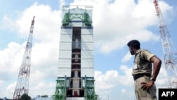 An Indian security troop patrols near the PSLV-C25 launch vehicle, carrying the Mars Orbiter probe as its payload, at the Indian Space Research Organization facility in Sriharikota on October 30.