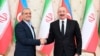 Azerbaijani President Ilham Aliyev (right) and Iranian President Masoud Pezeshkian shake hands after a joint news conference following talks in Baku on April 28, 2025.